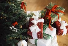 55 Best Christmas Gifts for 5-Year-Old Girls festively wrapped christmas gifts under a christmas tree with ornaments on it