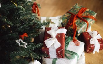 55 Best Christmas Gifts for 5-Year-Old Girls festively wrapped christmas gifts under a christmas tree with ornaments on it