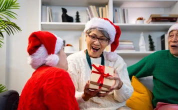 Grandma excited to open a Christmas gift with family