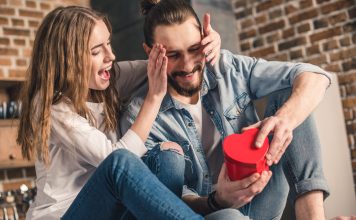 What Special Gift Can I Give My Boyfriend? 22 Ideas He’ll Actually Keep Woman surprising her boyfriend with a gift box
