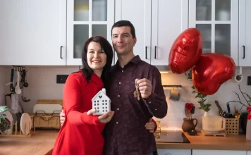 35 Best Housewarming Gifts They’ll Actually Use Couple holding the keys to their new home