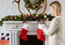 Woman putting a gift in a Christmas stocking
