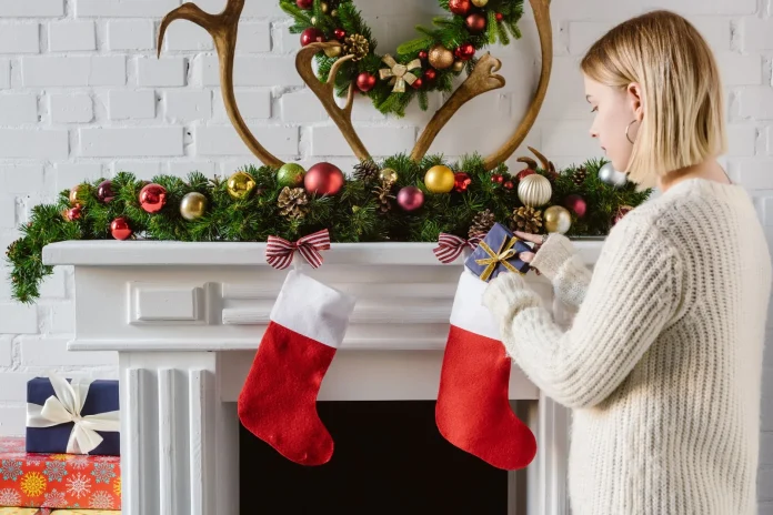 Woman putting a gift in a Christmas stocking