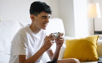 What Do You Buy a 15-Year-Old Boy Who Only Plays Video Games? Teen boy playing video games on a couch at home