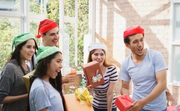 39 White Elephant Gift Ideas People Will Actually Fight Over Friends swapping gifts at a white elephant party